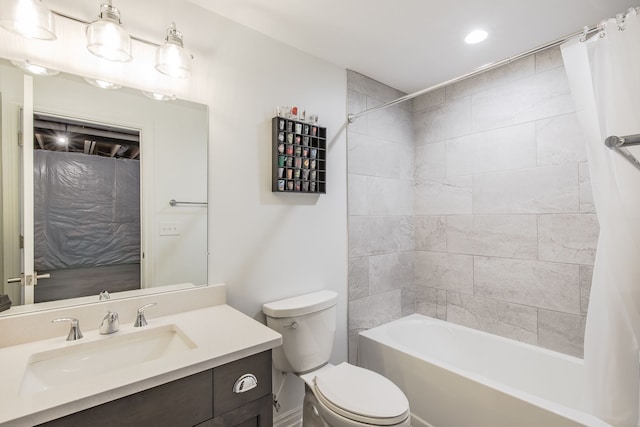 full bathroom with vanity, shower / bath combo, and toilet