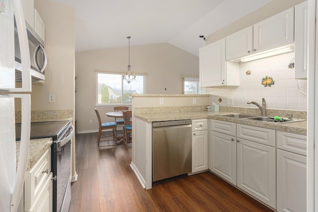 kitchen with sink, white cabinetry, kitchen peninsula, and appliances with stainless steel finishes