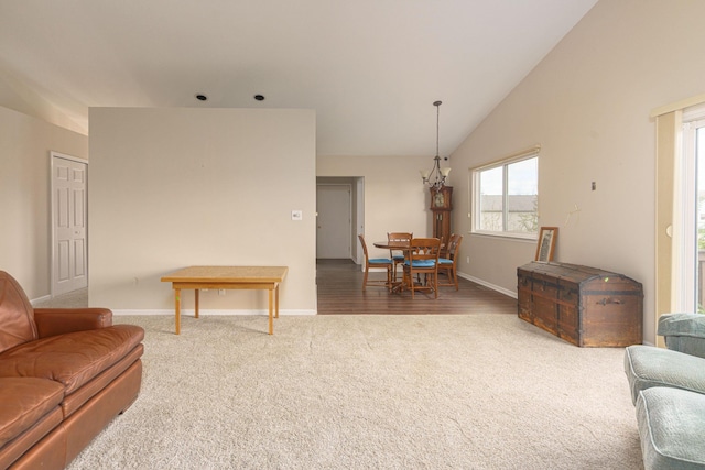 living room with dark colored carpet and lofted ceiling