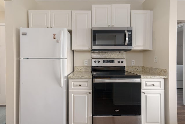 kitchen with wood-type flooring, stainless steel appliances, and white cabinetry