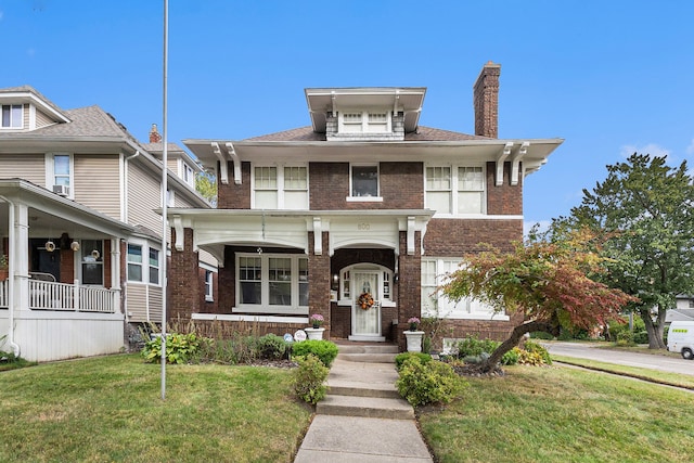 view of front of property with a porch and a front yard