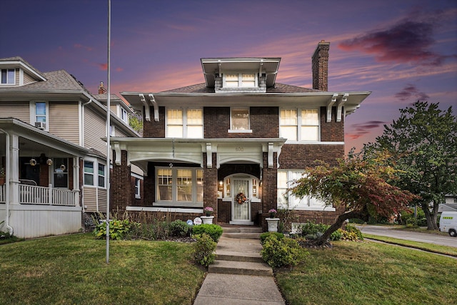 view of front of house featuring a porch and a lawn