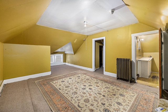 additional living space featuring radiator heating unit, carpet floors, and lofted ceiling