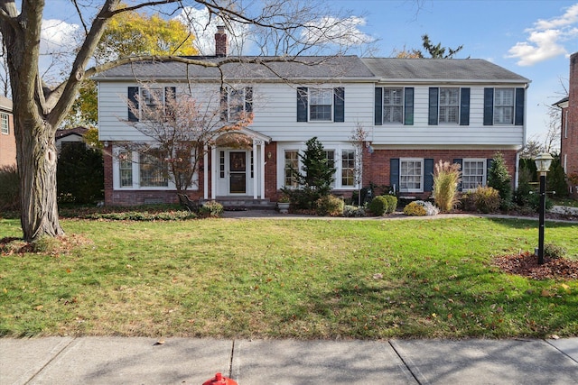 colonial-style house with a front yard