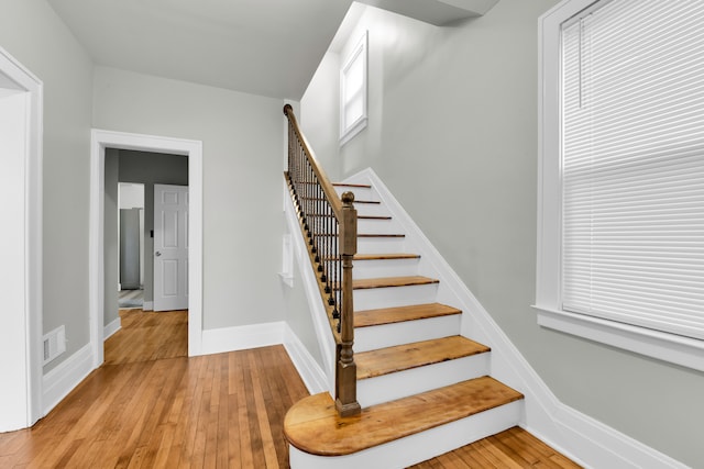 stairway with hardwood / wood-style floors