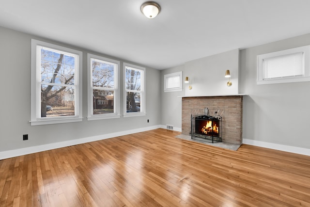 unfurnished living room with a fireplace and hardwood / wood-style flooring