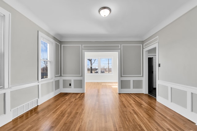 empty room with light hardwood / wood-style flooring