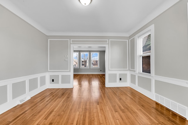 unfurnished room featuring a wealth of natural light and light hardwood / wood-style flooring