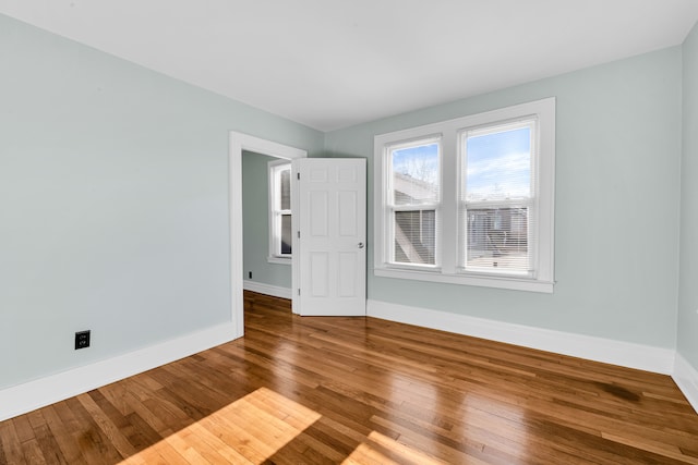 unfurnished room with hardwood / wood-style flooring