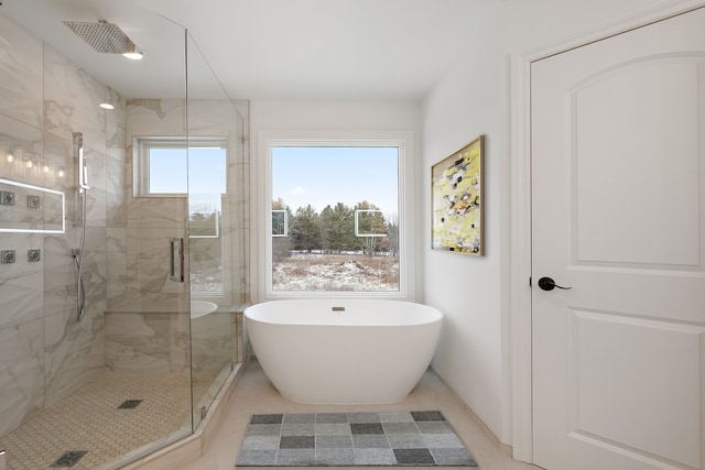 bathroom with tile patterned floors, plenty of natural light, and independent shower and bath