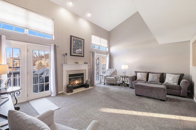 living room with light carpet and high vaulted ceiling