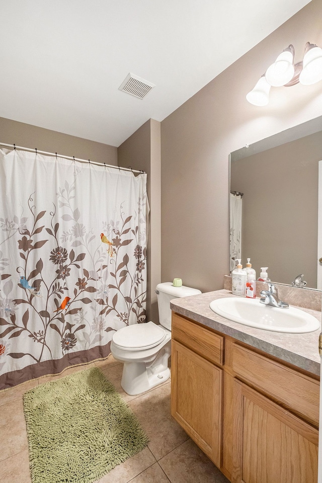 bathroom featuring toilet, vanity, and tile patterned floors