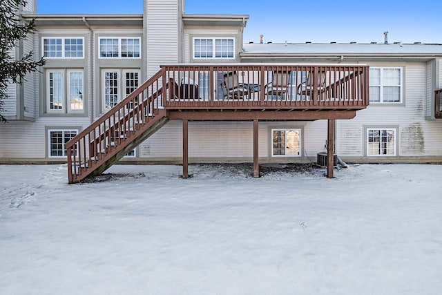 snow covered property featuring central AC unit