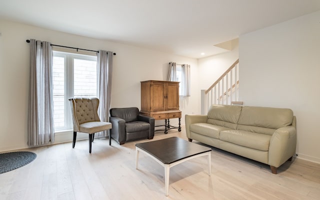 living room with light hardwood / wood-style floors and a wealth of natural light