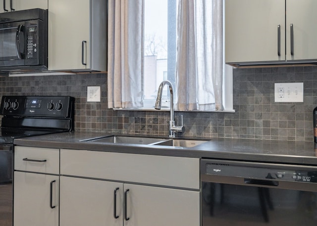 kitchen featuring white cabinets, decorative backsplash, sink, and black appliances