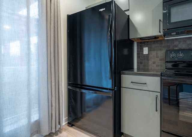 kitchen with decorative backsplash and black appliances