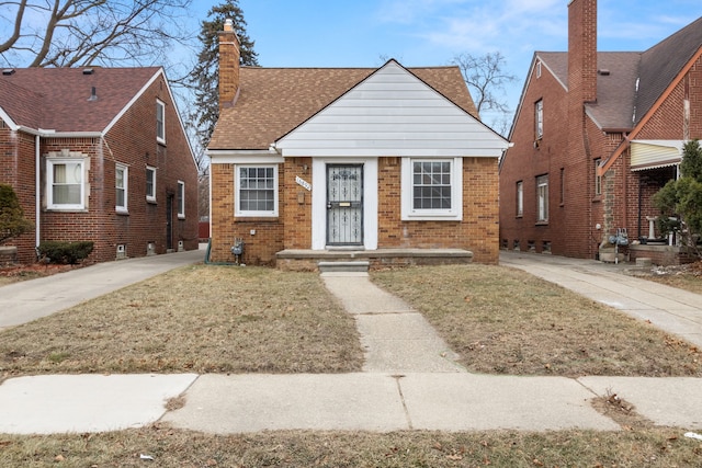 bungalow-style home featuring a front yard