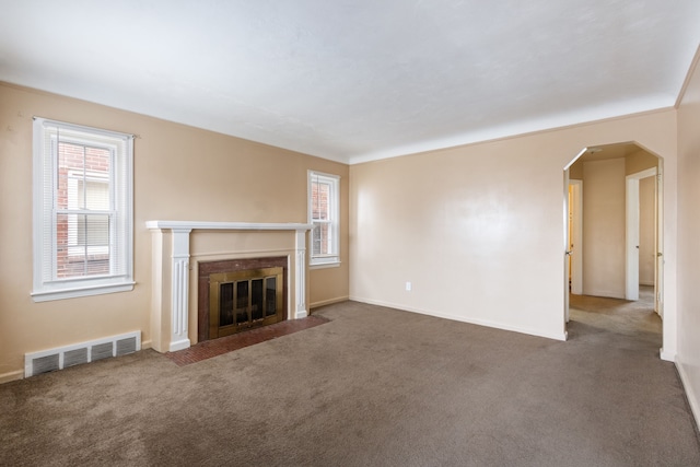 unfurnished living room with dark carpet