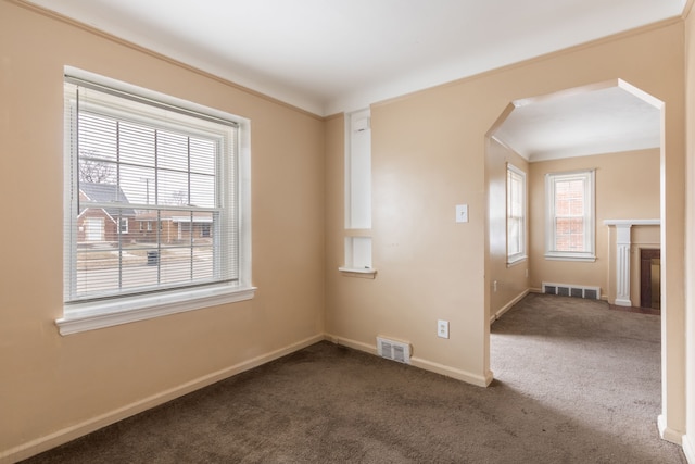 spare room featuring dark carpet