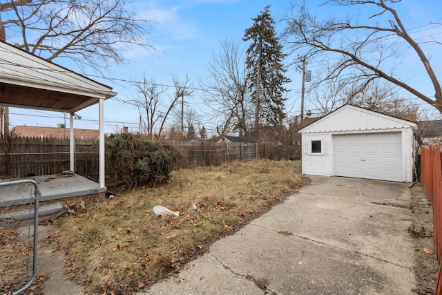 view of yard with a garage and an outbuilding