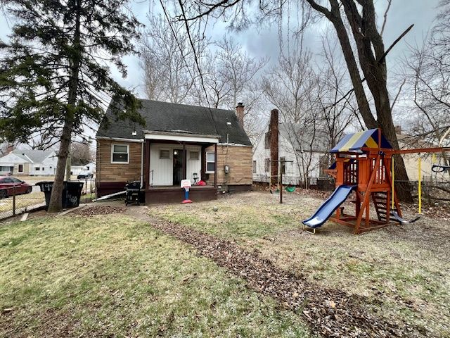 exterior space with a playground and a lawn