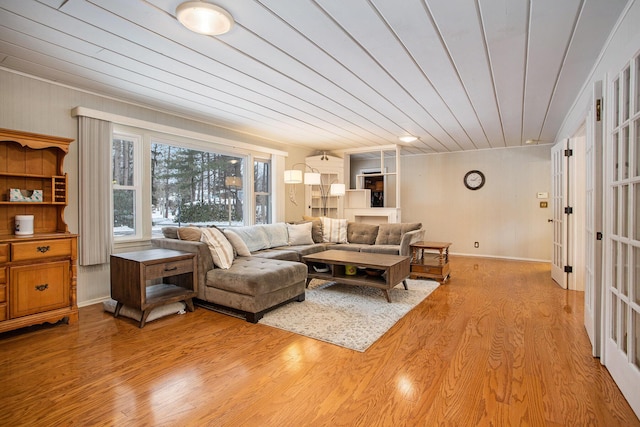 living room with wood ceiling and light hardwood / wood-style flooring