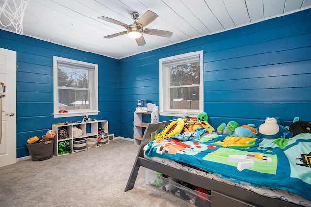 carpeted bedroom with multiple windows and ceiling fan