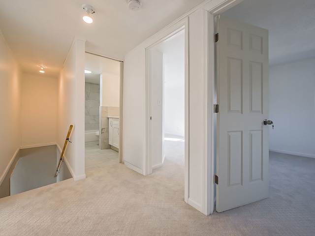 hall featuring light colored carpet