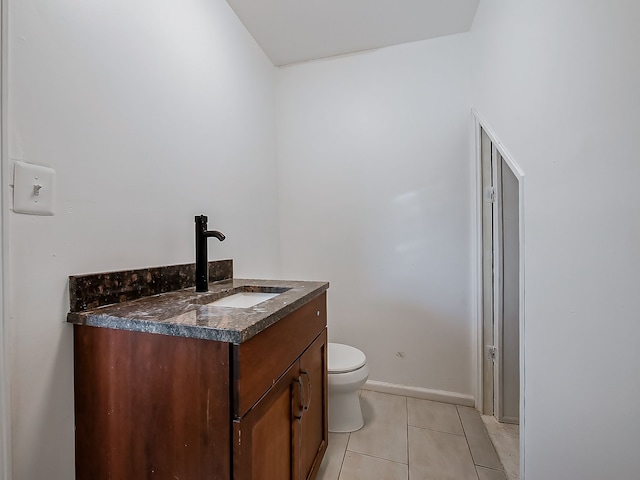 bathroom featuring tile patterned flooring, vanity, and toilet