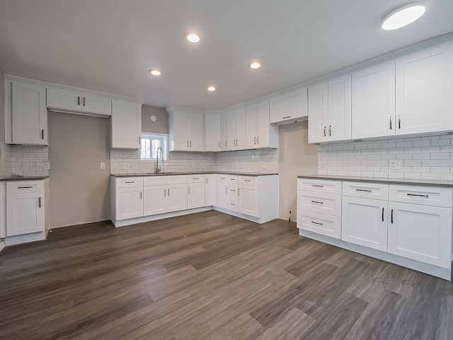 kitchen featuring sink, white cabinetry, and dark wood-type flooring