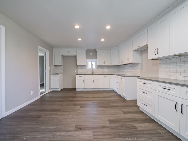 kitchen with sink, white cabinets, and dark wood-type flooring