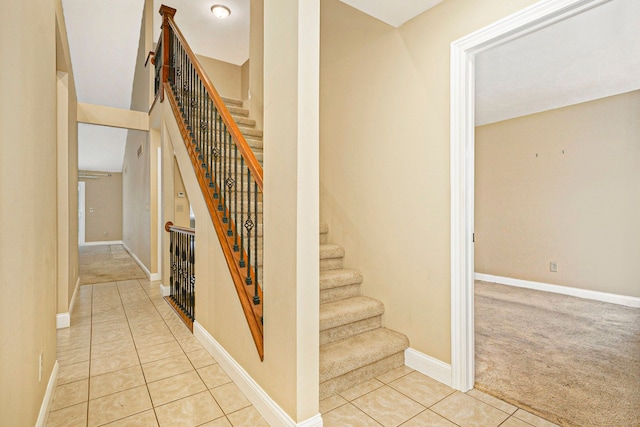 stairs featuring carpet, tile patterned flooring, and baseboards