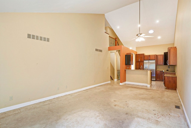 kitchen with brown cabinetry, open floor plan, visible vents, and stainless steel fridge with ice dispenser