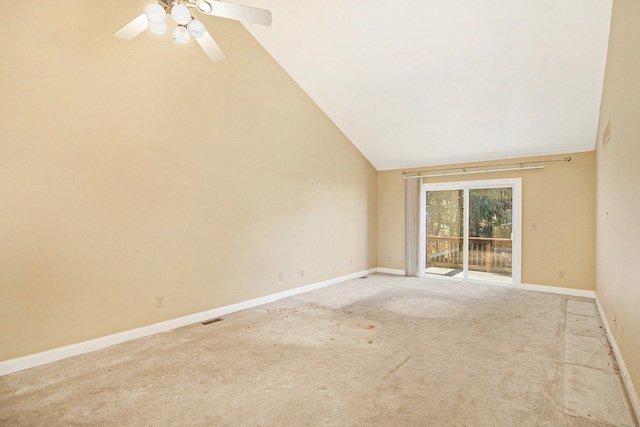 empty room with carpet flooring, a ceiling fan, visible vents, vaulted ceiling, and baseboards