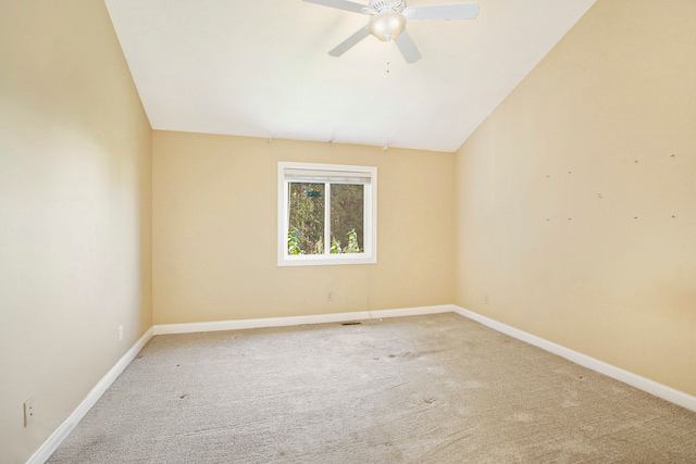 spare room with lofted ceiling, ceiling fan, carpet flooring, and baseboards