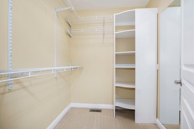 spacious closet featuring carpet and visible vents