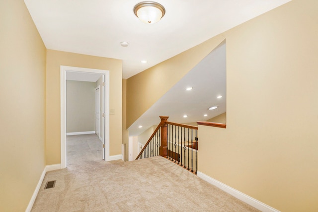 corridor with light colored carpet, baseboards, an upstairs landing, and recessed lighting