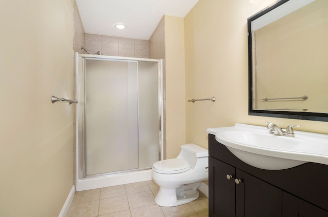 bathroom with toilet, vanity, baseboards, a shower stall, and tile patterned floors