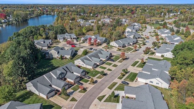 drone / aerial view with a water view and a residential view