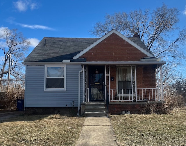 bungalow-style house with a front yard