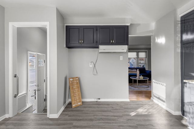 kitchen featuring dark hardwood / wood-style floors, radiator heating unit, and a wall mounted AC