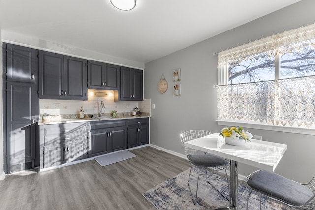 kitchen with decorative backsplash, sink, and dark wood-type flooring