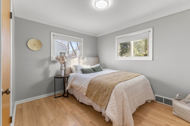 bedroom featuring hardwood / wood-style flooring and crown molding