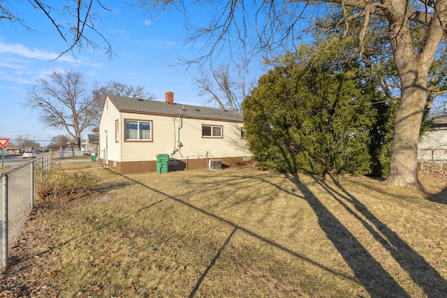 rear view of house featuring a lawn