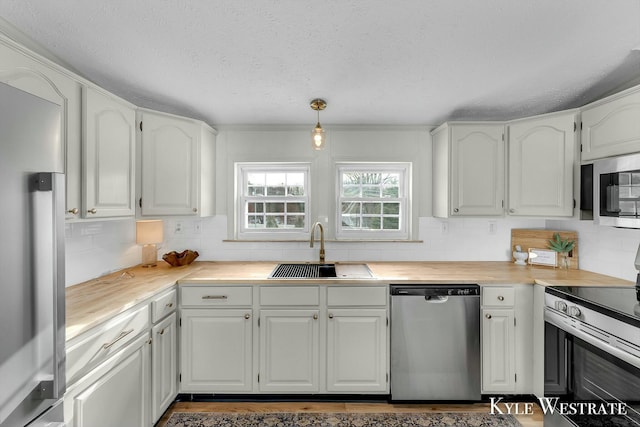 kitchen with sink, white cabinets, and stainless steel appliances