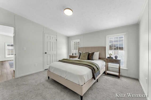 carpeted bedroom featuring a textured ceiling and vaulted ceiling