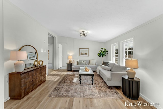 living room with lofted ceiling and light hardwood / wood-style flooring