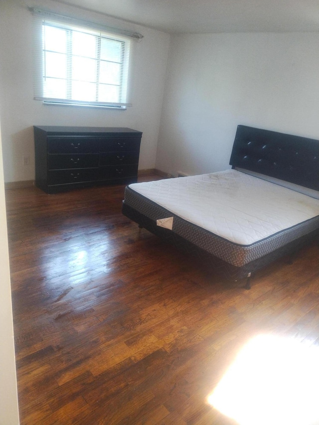 unfurnished bedroom featuring dark hardwood / wood-style floors