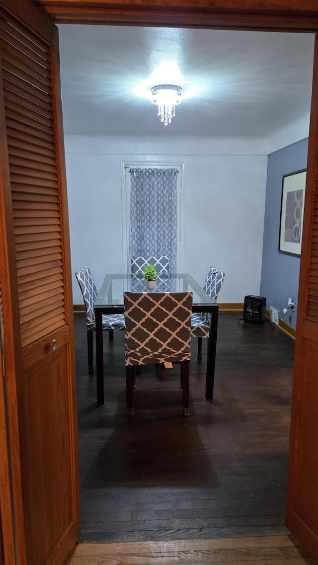 dining space featuring baseboards and wood finished floors