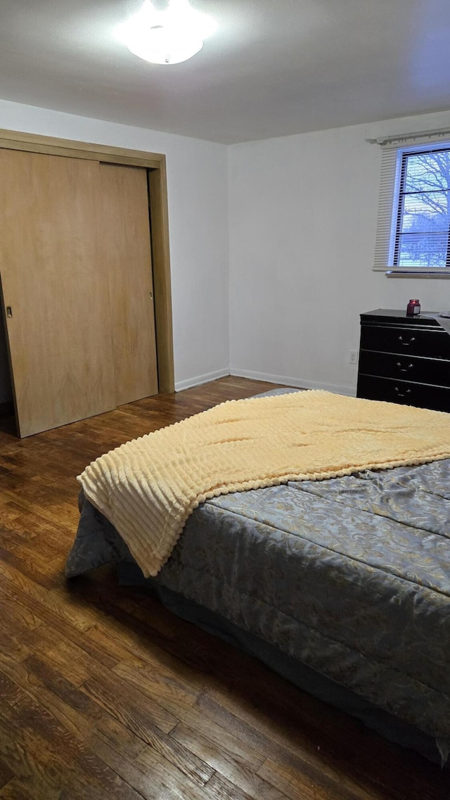 bedroom with a closet and wood finished floors